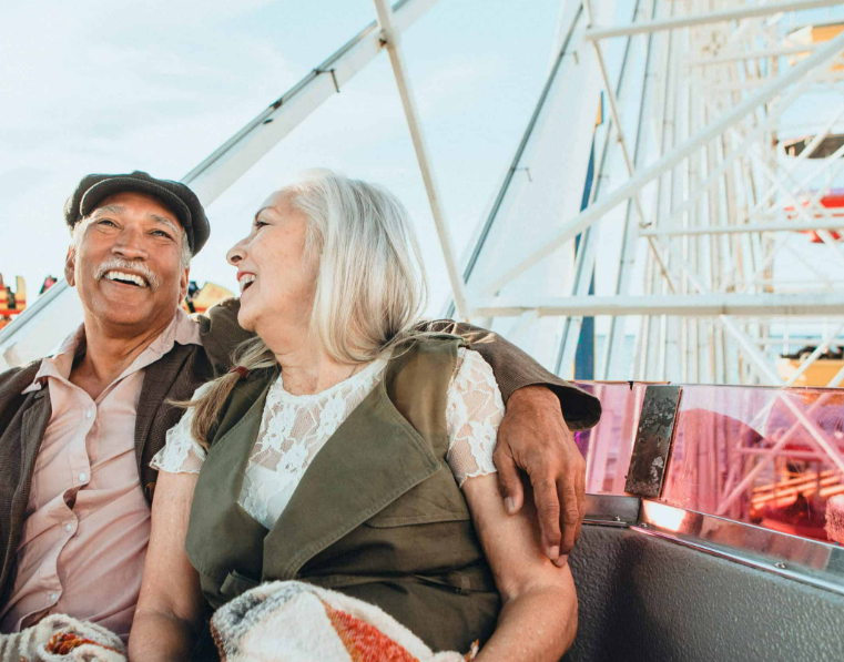 Mature couple laughing together while out enjoying the day