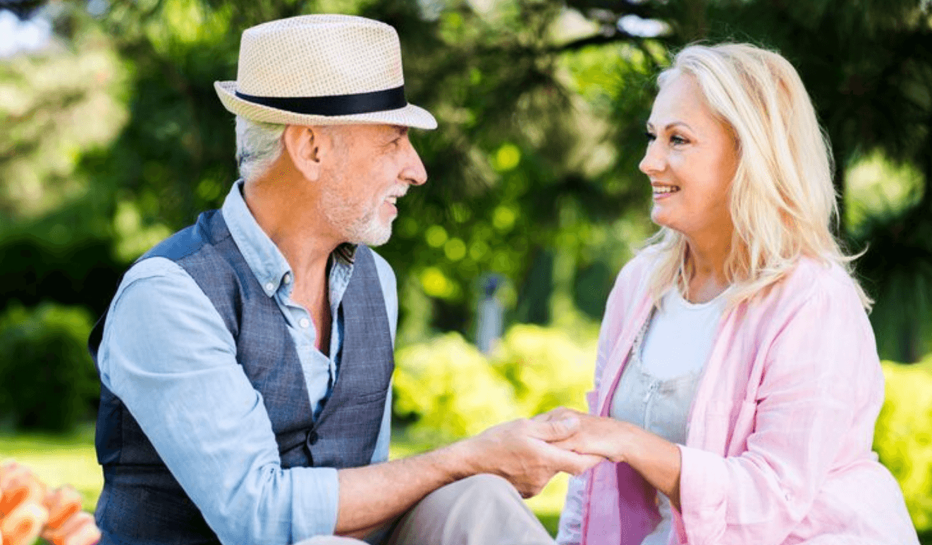 Mature couple holding hands in a garden