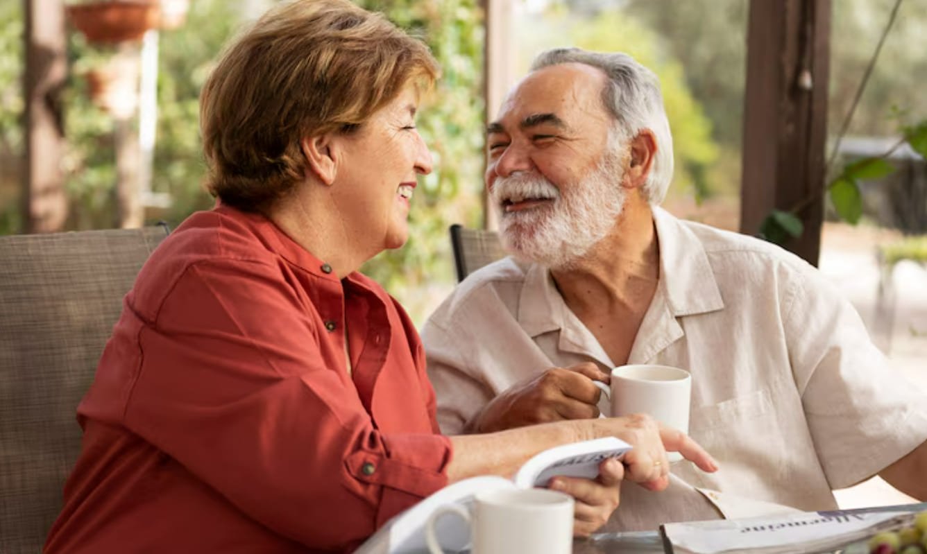 Mature couple talking closely at a table
