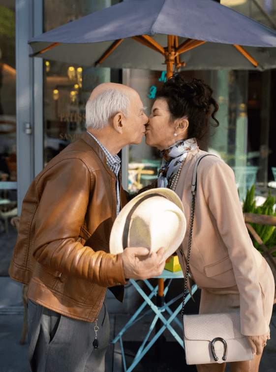 Mature couple sharing a kiss outside a cafe