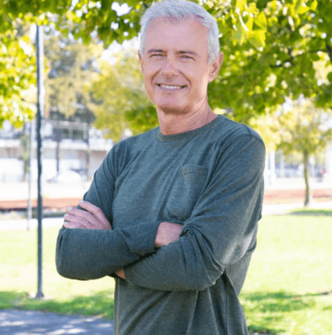Mature man smiling confidently outdoors