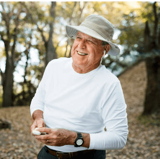 Mature man laughing confidently on an outdoor path