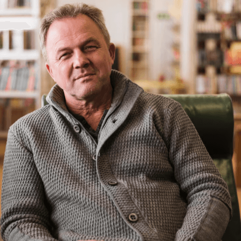 Mature man reading thoughtfully at home
