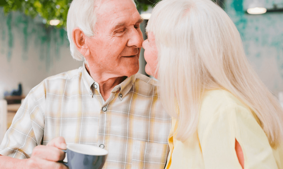Mature couple sharing a warm moment over coffee