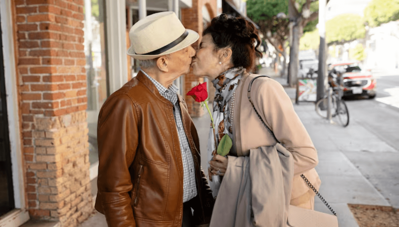 Mature couple sharing an affectionate moment on a city street