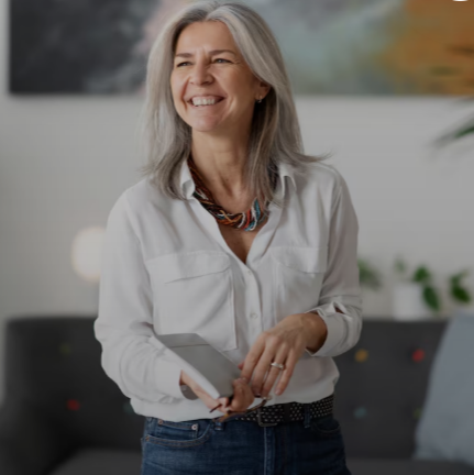 Mature woman smiling while looking at her phone