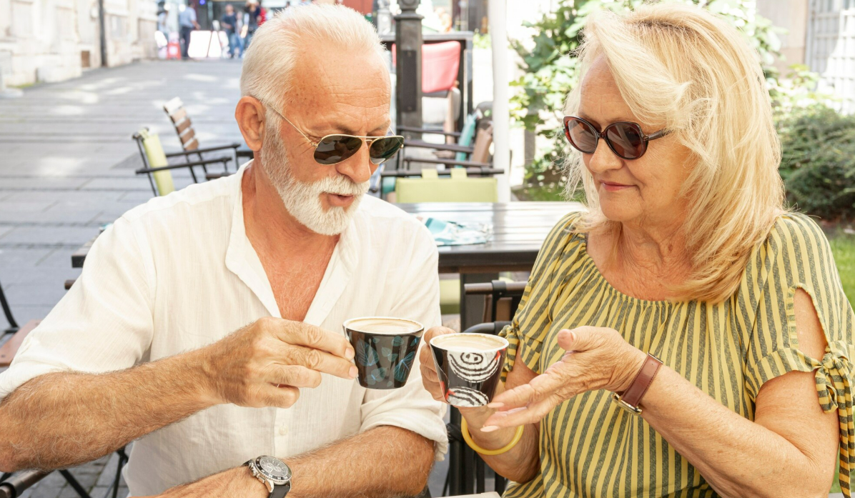 Mature couple having coffee together outdoors